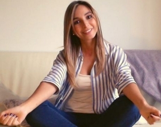 A young beautiful woman sitting on a sofa