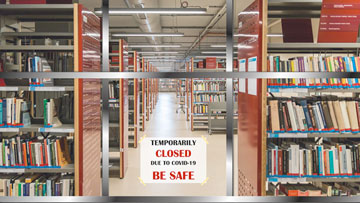 A closed library. On the glass door, a sign: 'Temporarily CLOSED due to covid-19. BE SAFE'