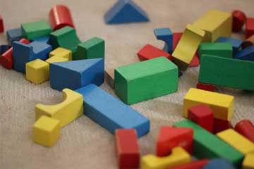 Children's bulding blocks of different colors sitting unorganizedly on the floor