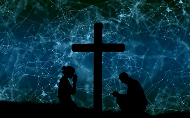 A depiction of the cosmos behind a picture of a black cross. 2 people are praying beside the cross